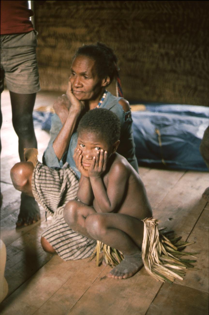 BD/166/184 -
Squating girl in a hut