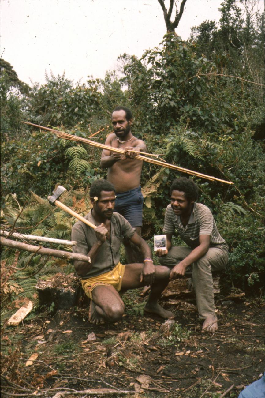 BD/166/29 -
Three men with hunting tools and Polaroids