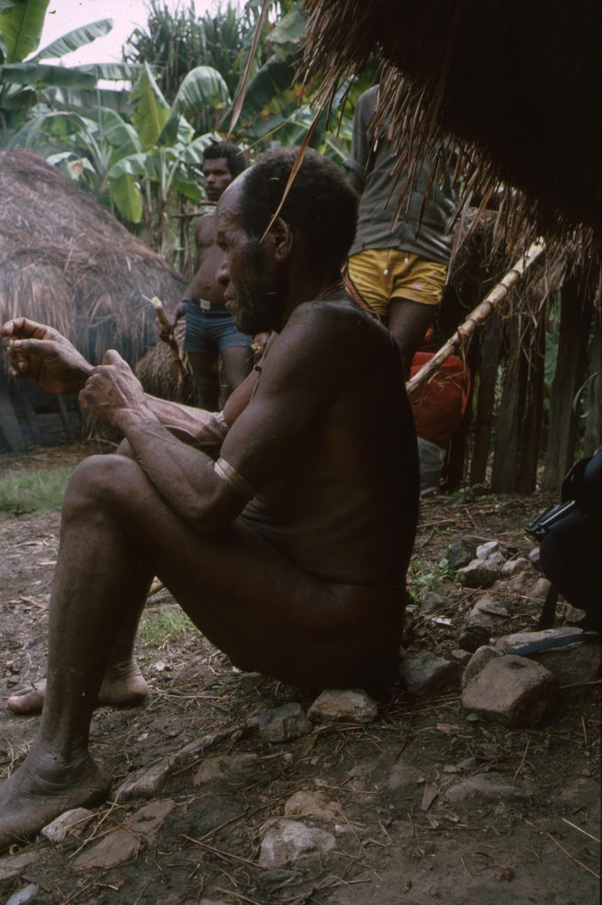BD/166/78 -
Man sitting on a row of stones 1