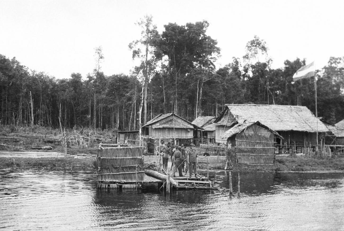 BD/133/215 -
Een nederzetting met aanlegsteiger aan de rivier