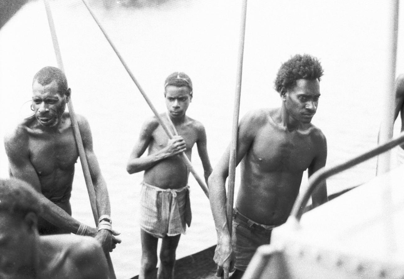 BD/133/650 -
Portret van Papoea-mannen en Papoea-jongen, met peddels staand in prauw