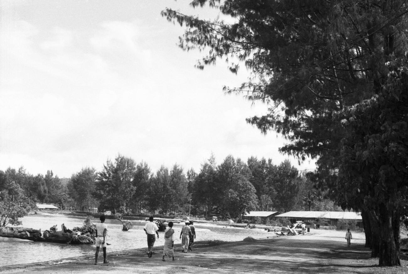 BD/133/901 -
Straatbeeld met langs de rivier wandelende mensen