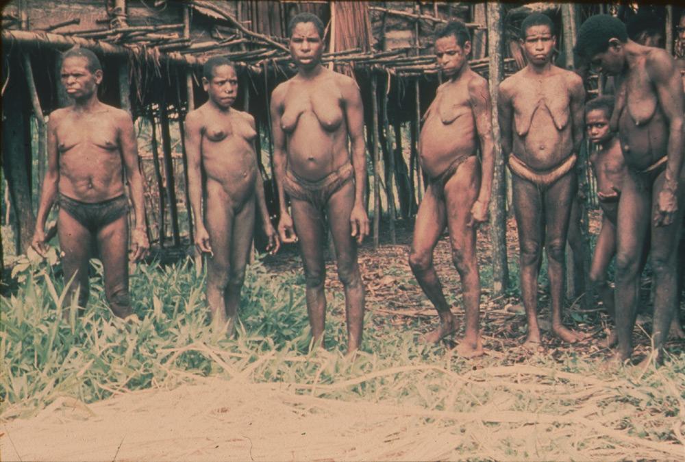 BD/30/42 -
Some Asmat women in front of a stilt house