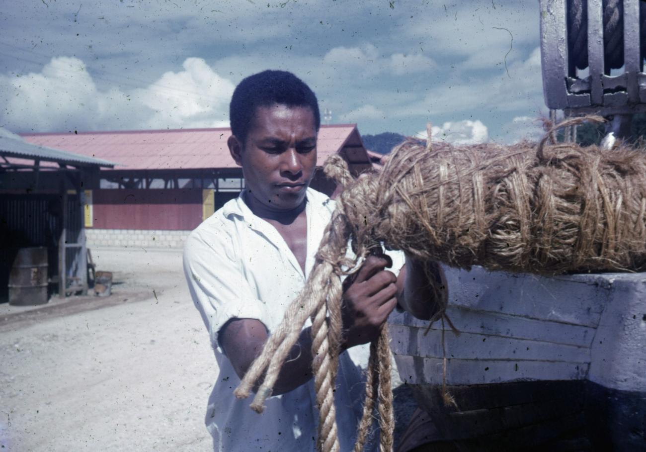 BD/66/33 -
Man with ropes near a boat dock